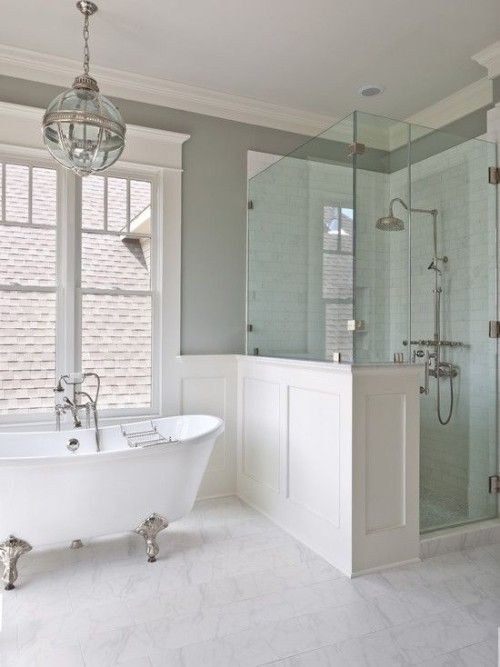 Remodeled bathroom with a freestanding tub, glass shower and pendant lighting