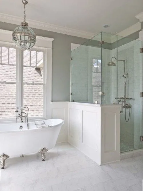 Remodeled bathroom with a freestanding tub, glass shower and pendant lighting