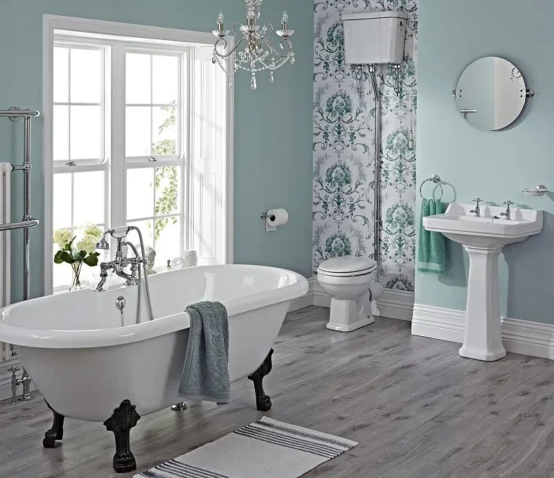 Finished bathroom with a clawfoot tub, pedestal sink and tiled floor