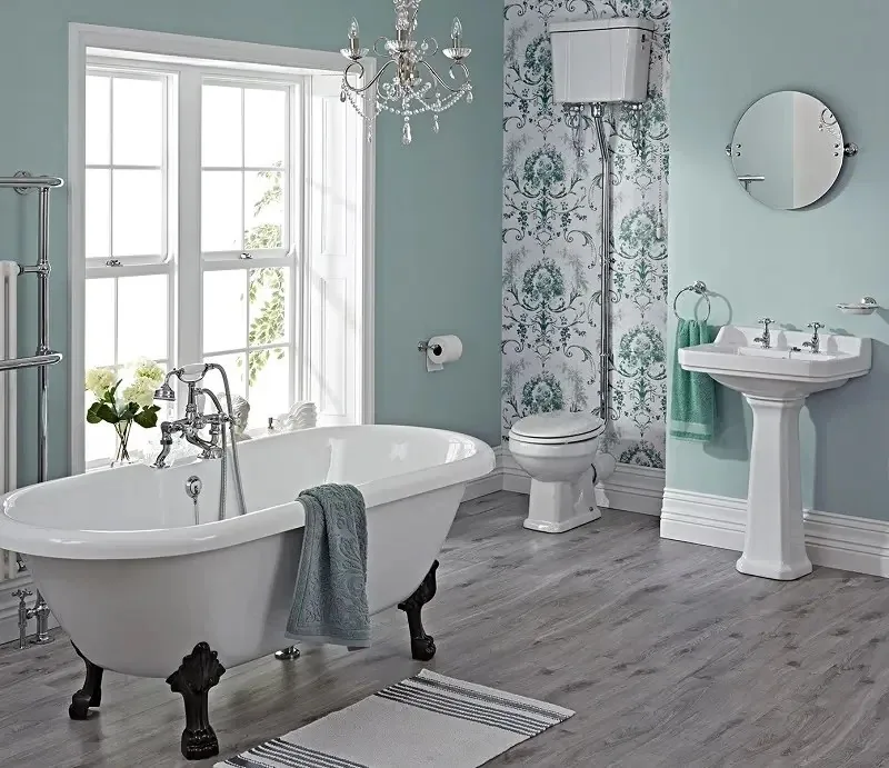 Finished bathroom with a clawfoot tub, pedestal sink and tiled floor