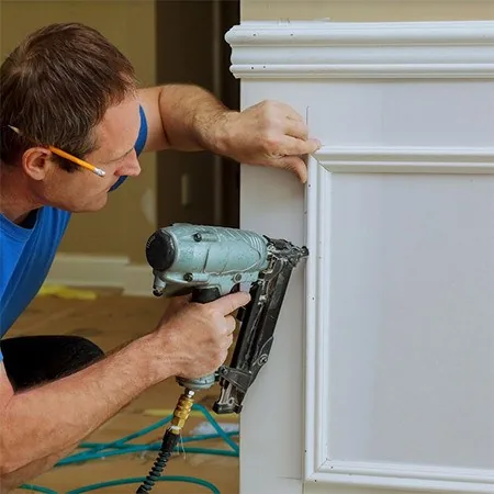 Finish carpenter fitting trim with a pneumatic nailer